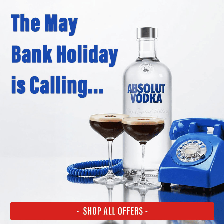 Absolut Vodka with two espresso martinis in front of a blue classic telephone
